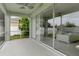 Enjoy an enclosed porch with tiled floor overlooking the green backyard and white fence at 4215 Maplehurst Way, Spring Hill, FL 34609