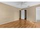 Bedroom with hardwood floors, ceiling fan, and view of an open closet space at 4221 San Rafael Ave, New Port Richey, FL 34655