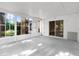 Enclosed Florida room with large windows and sliding glass doors at 4221 San Rafael Ave, New Port Richey, FL 34655