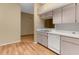 Practical kitchen layout with white countertops and cabinets, open to adjacent living spaces at 4221 San Rafael Ave, New Port Richey, FL 34655