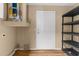 Utility room with water heater, door, and shelving unit at 4221 San Rafael Ave, New Port Richey, FL 34655