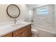 Bathroom featuring a vanity, sink, round mirror, and tiled shower over tub at 4468 Rudder Way, New Port Richey, FL 34652
