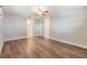 Spacious bedroom with wood-look flooring and ample natural light from a ceiling fan at 4468 Rudder Way, New Port Richey, FL 34652