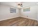 Comfortable bedroom with wood-look floors, and two sunny windows at 4468 Rudder Way, New Port Richey, FL 34652