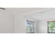 Bedroom with wood look flooring, white walls, and bright windows at 4468 Rudder Way, New Port Richey, FL 34652