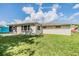 Exterior view of the home featuring a well-maintained lawn and neutral paint at 4468 Rudder Way, New Port Richey, FL 34652