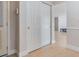 Hallway with white closet doors and neutral walls and floor, leading to other rooms at 4468 Rudder Way, New Port Richey, FL 34652