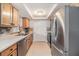 Well-lit kitchen featuring stainless steel appliances and warm wood cabinetry at 4468 Rudder Way, New Port Richey, FL 34652