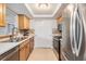 Kitchen with stainless steel appliances, wood cabinets, and tile flooring at 4468 Rudder Way, New Port Richey, FL 34652