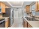 Updated kitchen featuring stainless steel appliances, wooden cabinetry, and bright lighting at 4468 Rudder Way, New Port Richey, FL 34652