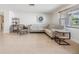 Bright living room with tile floors, a comfortable seating arrangement, and natural light at 4468 Rudder Way, New Port Richey, FL 34652