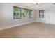 Bright room featuring tile floors, large windows, and a ceiling fan at 4468 Rudder Way, New Port Richey, FL 34652