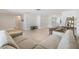 Open-concept living room featuring tile flooring and a comfortable seating arrangement at 4468 Rudder Way, New Port Richey, FL 34652