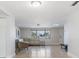 Bright living room features tile flooring, a large sectional sofa, and natural light from the window at 4468 Rudder Way, New Port Richey, FL 34652