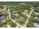 An aerial view showcases the home's location within a lush, green neighborhood at 4595 Lake In The Woods Dr, Spring Hill, FL 34607