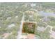 Property aerial view showcasing the home's location and surrounding landscape with boundary lines at 4595 Lake In The Woods Dr, Spring Hill, FL 34607