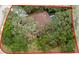 Property aerial view highlighting the home, pool, and surrounding lot with boundary lines at 4595 Lake In The Woods Dr, Spring Hill, FL 34607