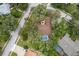 An aerial view reveals the home with a private pool surrounded by lush landscaping at 4595 Lake In The Woods Dr, Spring Hill, FL 34607
