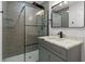 Contemporary bathroom featuring a gray tile shower with a glass enclosure at 4595 Lake In The Woods Dr, Spring Hill, FL 34607