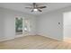 Bedroom with wood-look floors and glass patio doors to the yard at 4595 Lake In The Woods Dr, Spring Hill, FL 34607