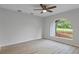 Cozy bedroom with light wood floors, a neutral color palette, vaulted ceilings, and an arched window at 4595 Lake In The Woods Dr, Spring Hill, FL 34607