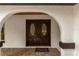 Elegant home entrance showcasing an arched entryway and beautiful wooden double doors with decorative glass at 4595 Lake In The Woods Dr, Spring Hill, FL 34607