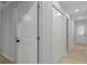 Hallway with linen closet featuring wood-look floors and neutral walls at 4595 Lake In The Woods Dr, Spring Hill, FL 34607