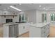 Bright kitchen features granite counters, stainless steel appliances and white cabinets at 4595 Lake In The Woods Dr, Spring Hill, FL 34607