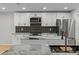 Modern kitchen features granite counters, stainless steel appliances, and a black tile backsplash at 4595 Lake In The Woods Dr, Spring Hill, FL 34607