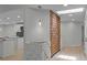 Bright living room with wood floors, a decorative wall, and an open floor plan to the kitchen area at 4595 Lake In The Woods Dr, Spring Hill, FL 34607