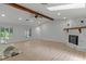 Expansive living room with a stone fireplace, skylight, and a view of the pool at 4595 Lake In The Woods Dr, Spring Hill, FL 34607