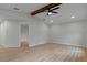 Bright and airy living room featuring light wood floors and vaulted ceilings with wood beam at 4595 Lake In The Woods Dr, Spring Hill, FL 34607