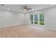 Large room with sliding glass doors leading to a garden and pool at 4595 Lake In The Woods Dr, Spring Hill, FL 34607