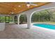 Spacious outdoor living area with a pool, covered ceilings, and tiled flooring at 4595 Lake In The Woods Dr, Spring Hill, FL 34607