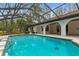 An enclosed pool features ample patio space and an outdoor living area at 4595 Lake In The Woods Dr, Spring Hill, FL 34607
