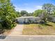 Attractive single-Gathering home featuring an attached garage and a cozy front yard at 5045 Grand Blvd, New Port Richey, FL 34652