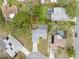 Aerial view of property showcasing the home, pool, surrounding trees, and proximity to nearby homes at 5087 Oyster Ct, Spring Hill, FL 34607