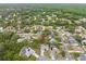 Aerial view of a home in a lush, green neighborhood with mature trees at 5087 Oyster Ct, Spring Hill, FL 34607