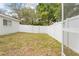 Backyard showcasing the white vinyl privacy fence and lush, mature landscaping at 5087 Oyster Ct, Spring Hill, FL 34607