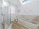 Bathroom with shower, tub, and window for natural light at 5087 Oyster Ct, Spring Hill, FL 34607