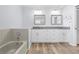 Bright bathroom features a double sink vanity, tub, and modern finishes at 5087 Oyster Ct, Spring Hill, FL 34607
