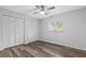 Bedroom with ceiling fan, wood floors, and closet at 5087 Oyster Ct, Spring Hill, FL 34607