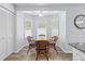 Cozy dining nook with a glass-top table, wicker chairs, and natural light from the bay window at 5087 Oyster Ct, Spring Hill, FL 34607