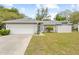 Charming single-story home with a well-maintained lawn and a two-car garage at 5087 Oyster Ct, Spring Hill, FL 34607
