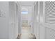 Hallway with closet doors leading to a bright bathroom featuring a skylight at 5087 Oyster Ct, Spring Hill, FL 34607