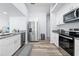Modern kitchen with white cabinets, stainless steel appliances, and granite countertops at 5087 Oyster Ct, Spring Hill, FL 34607