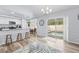 Open living space with wood floors, kitchen access, and sliding door access to pool area at 5087 Oyster Ct, Spring Hill, FL 34607