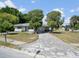 Charming single-story home with a spacious driveway and well-established trees in the front yard at 5154 Allamanda Dr, New Port Richey, FL 34652