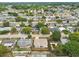 An aerial view of a residential neighborhood featuring single-story homes with mature trees and landscaping at 5642 Dove Dr, New Port Richey, FL 34652
