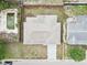 Overhead view of the house, revealing backyard space, fence lines, and a view of an adjacent empty pool at 5642 Dove Dr, New Port Richey, FL 34652
